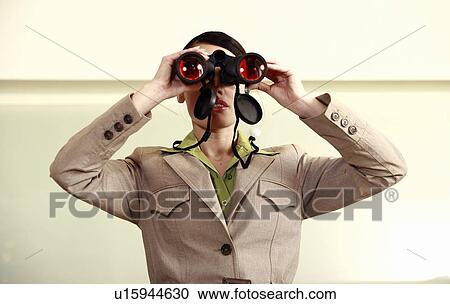 Woman with binoculars standing on counter in eyeglass store View Large Photo Image Stock Image - Woman with binoculars standing on counter in eyeglass store. Fotosearch