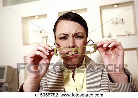 Woman with eyeglasses squinting View Large Photo Image Stock Image - Woman with eyeglasses squinting. Fotosearch