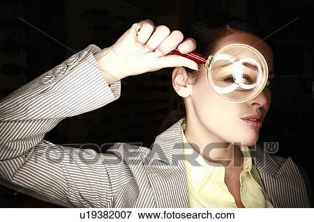Woman with magnifying glass on eye View Large Photo Image Stock Photo - Woman with magnifying glass on eye. Fotosearch