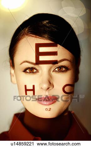 Stock Image - Woman with optical exam characters on her face. Fotosearch