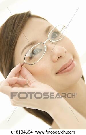 Picture - A woman wearing glasses, front view, close up, white background. Fotosearch