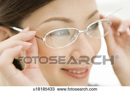 A woman wearing glasses, side view, close up, differential focus View Large Photo Image Stock Image - A woman wearing glasses, side view, close up, differential focus. Fotosearch