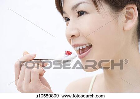 Close up of young woman eating a strawberry, side view View Large Photo Image Stock Photo - Close up of young woman eating a strawberry, side view. Fotosearch