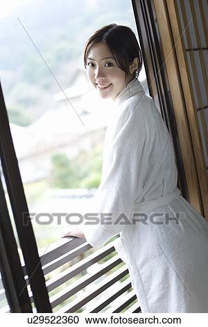Portrait of a woman in bathrobe by the window, smiling and looking at camera, side view, Japan View Large Photo Image Stock Image - Portrait of a woman in bathrobe by the window, smiling and looking at camera, side view, Japan. Fotosearch