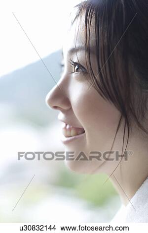 Picture - Profile of a woman in bathrobe, smiling, side view, close up, Japan. Fotosearch