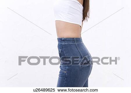 Stock Photography - Woman wearing jeans, side view. Fotosearch