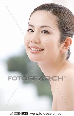Young woman, smiling, front view View Large Photo Image Stock Photo - Young woman, smiling, front view. Fotosearch