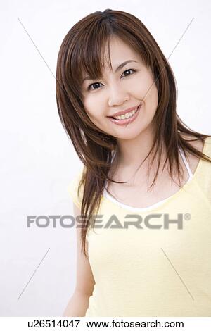 Stock Photo - Young woman, smiling, front view. Fotosearch