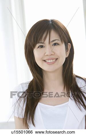 Young woman, smiling, front view View Large Photo Image Stock Photograph - Young woman, smiling, front view. Fotosearch
