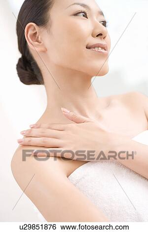 Young woman, smiling, low angle view View Large Photo Image Stock Photograph - Young woman, smiling, low angle view. Fotosearch