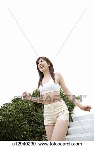 Young woman walking down steps, low angle view View Large Photo Image Stock Image - Young woman walking down steps, low angle view . Fotosearch