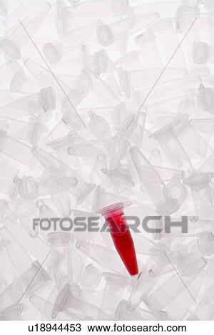 Stock Image - Mass of micro test tubes, one filled with chemical, high angle view, full frame, white background. Fotosearch