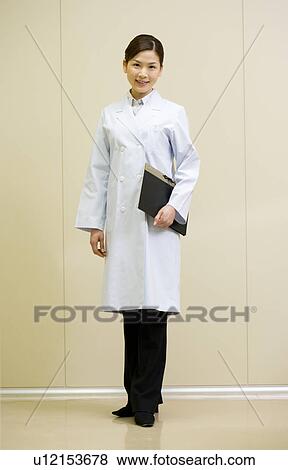 Portrait of a female scientist, smiling and looking at camera, front view View Large Photo Image Stock Photo - Portrait of a female scientist, smiling and looking at camera, front view. Fotosearch
