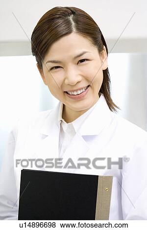 Portrait of a female scientist, smiling and looking at camera, front view View Large Photo Image Stock Photo - Portrait of a female scientist, smiling and looking at camera, front view. Fotosearch