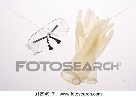 Protective gloves and goggles, high angle view, white background View Large Photo Image Stock Image - Protective gloves and goggles, high angle view, white background. Fotosearch