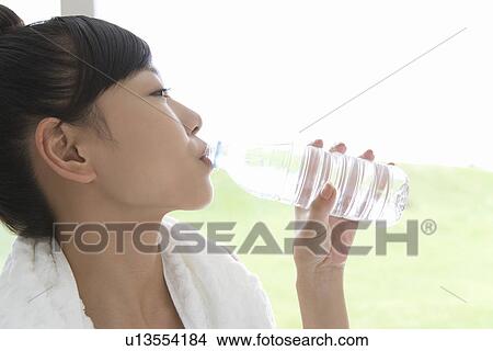 Close up of a young woman drinking water, side view View Large Photo Image Picture - Close up of a young woman drinking water, side view. Fotosearch