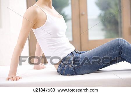 Young women sitting on white mat, side view View Large Photo Image Stock Image - Young women sitting on white mat, side view. Fotosearch