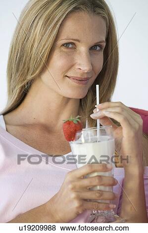 A woman drinking a health drink View Large Photo Image Stock Photo - A woman drinking a health drink. Fotosearch