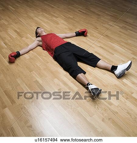A Boxer Laying On The Floor Picture U Fotosearch