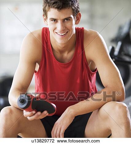Stock Image - A young man at a gym. Fotosearch