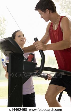 A young man exercising with a personal trainer View Large Photo Image Stock Photo - A young man exercising with a personal trainer. Fotosearch