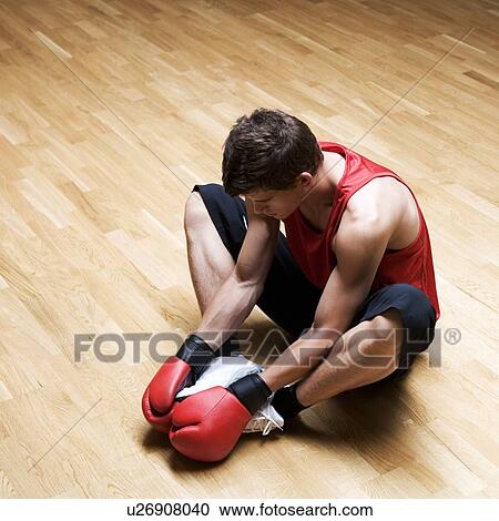A young man wearing boxing gloves View Large Photo Image Stock Image - A young man wearing boxing gloves. Fotosearch