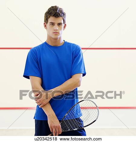 Stock Photo - A young man with a squash racket. Fotosearch