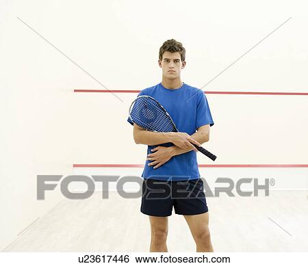 Stock Photograph - A young man with a squash racket. Fotosearch