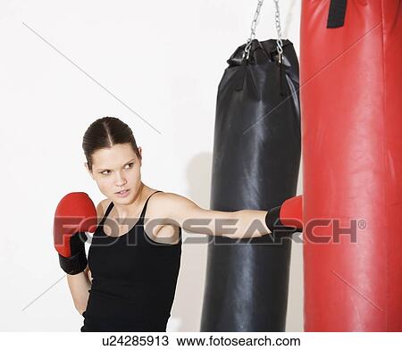 Stock Image - A young woman boxing. Fotosearch