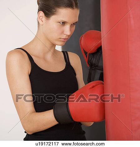 Stock Photo - A young woman boxing. Fotosearch