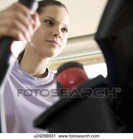 A young woman exercising View Large Photo Image Stock Image - A young woman exercising. Fotosearch