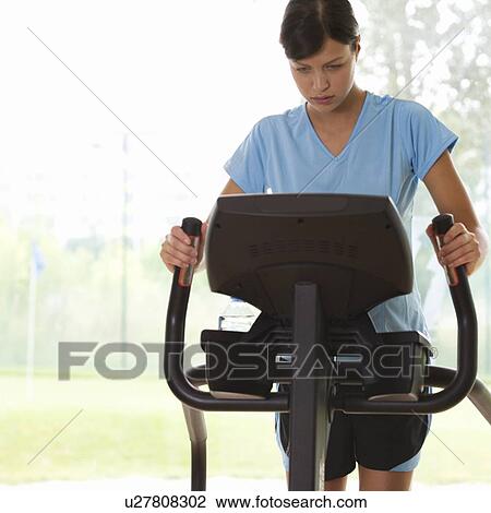 Stock Image - A young woman exercising. Fotosearch