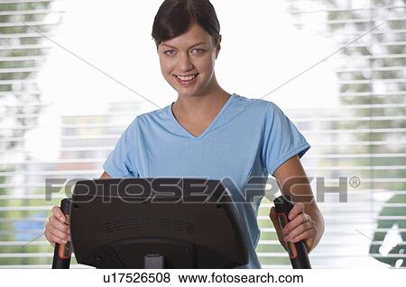 Stock Photo - A young woman exercising. Fotosearch