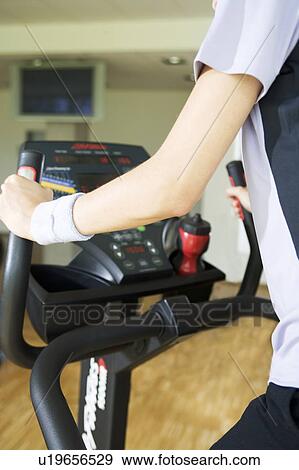 Stock Photo - A young woman exercising. Fotosearch