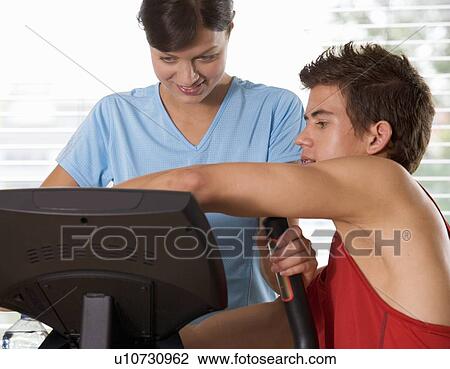 A young woman with a personal trainer View Large Photo Image Stock Image - A young woman with a personal trainer. Fotosearch