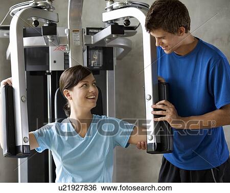 A young woman with a personal trainer View Large Photo Image Stock Photograph - A young woman with a personal trainer. Fotosearch