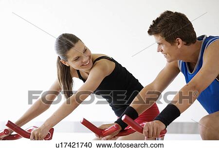 Stock Image - Two young people exercising. Fotosearch