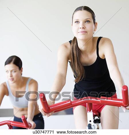 Two young women exercising View Large Photo Image Stock Image - Two young women exercising. Fotosearch