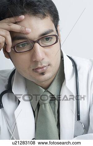 Stock Photo - Close-up of a male doctor thinking. Fotosearch