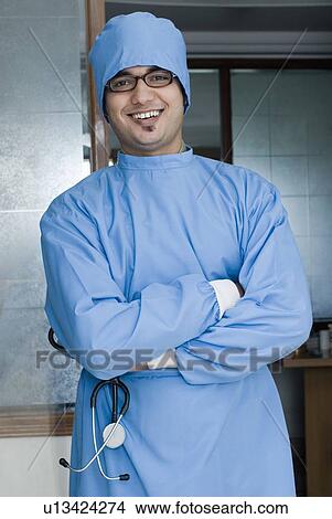 Close-up of a surgeon holding a stethoscope and smiling View Large Photo Image Picture - Close-up of a surgeon holding a stethoscope and smiling. Fotosearch