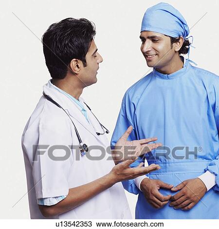 Stock Image - Close-up of two male doctors discussing. Fotosearch
