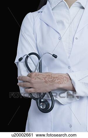 Mid section view of a female doctor holding a stethoscope View Large Photo Image Stock Image - Mid section view of a female doctor holding a stethoscope. Fotosearch