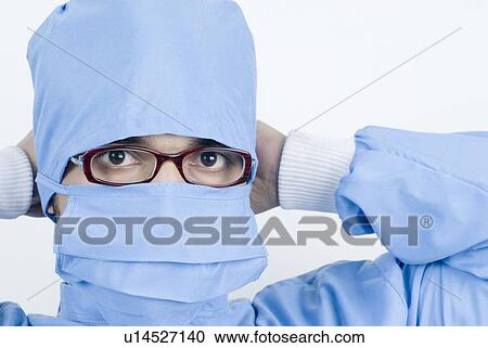 Portrait of a surgeon tying his surgical mask View Large Photo Image Stock Image - Portrait of a surgeon tying his surgical mask. Fotosearch