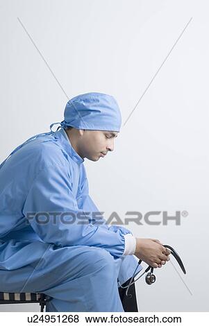 Side profile of a surgeon sitting and thinking View Large Photo Image Stock Photo - Side profile of a surgeon sitting and thinking. Fotosearch