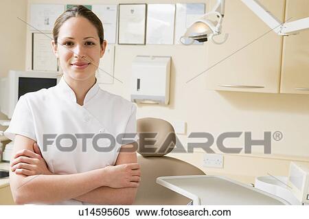 Dental assistant in exam room smiling View Large Photo Image Stock Photography - Dental assistant in exam room smiling. Fotosearch
