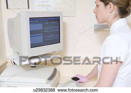 Dental assistant using computer View Large Photo Image Stock Photo - Dental assistant using computer. Fotosearch