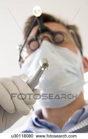 Dentist holding drill View Large Photo Image Stock Image - Dentist holding drill. Fotosearch