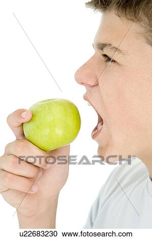 Stock Image - Boy eating apple. Fotosearch