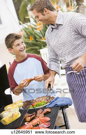 Father And Son Barbequing View Large Photo Image Stock Image - Father And Son Barbequing. Fotosearch