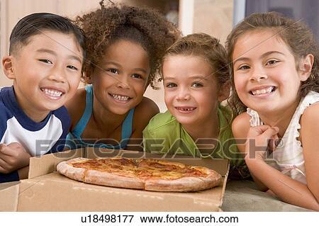 Four young children indoors with pizza smiling View Large Photo Image Stock Photo - Four young children indoors with pizza smiling. Fotosearch